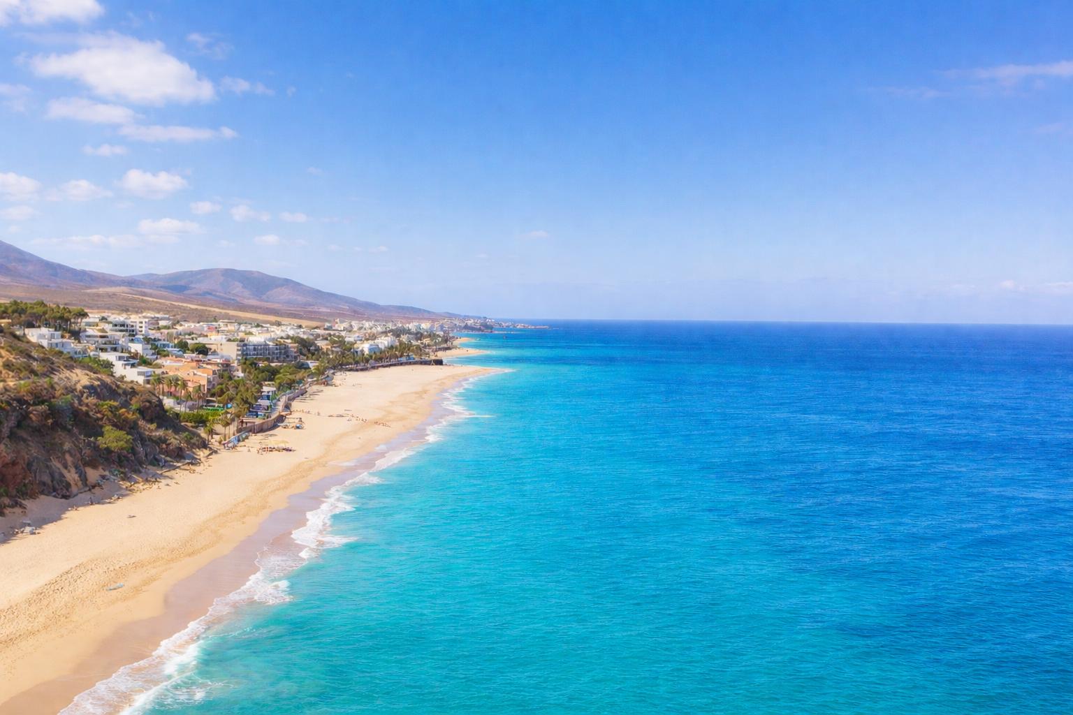 Aerial coastline view in Fuerteventura with turquoise ocean and sandy beach
